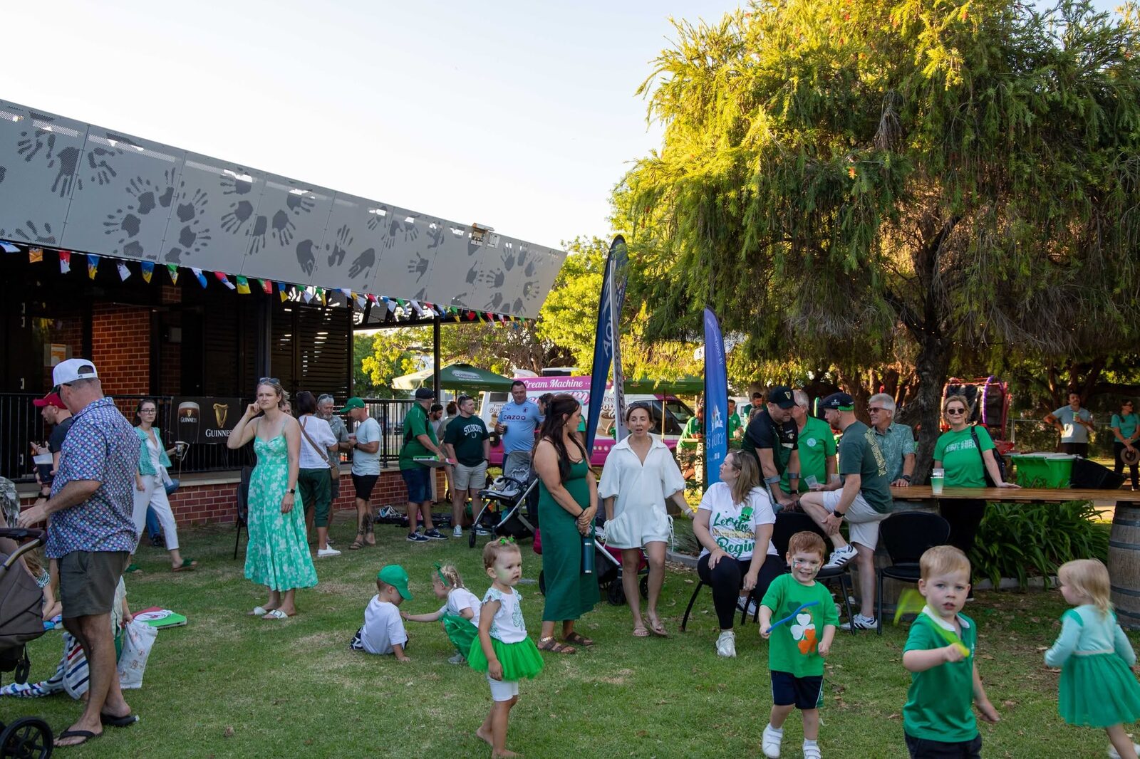 Families and children on the grass in green at the festival